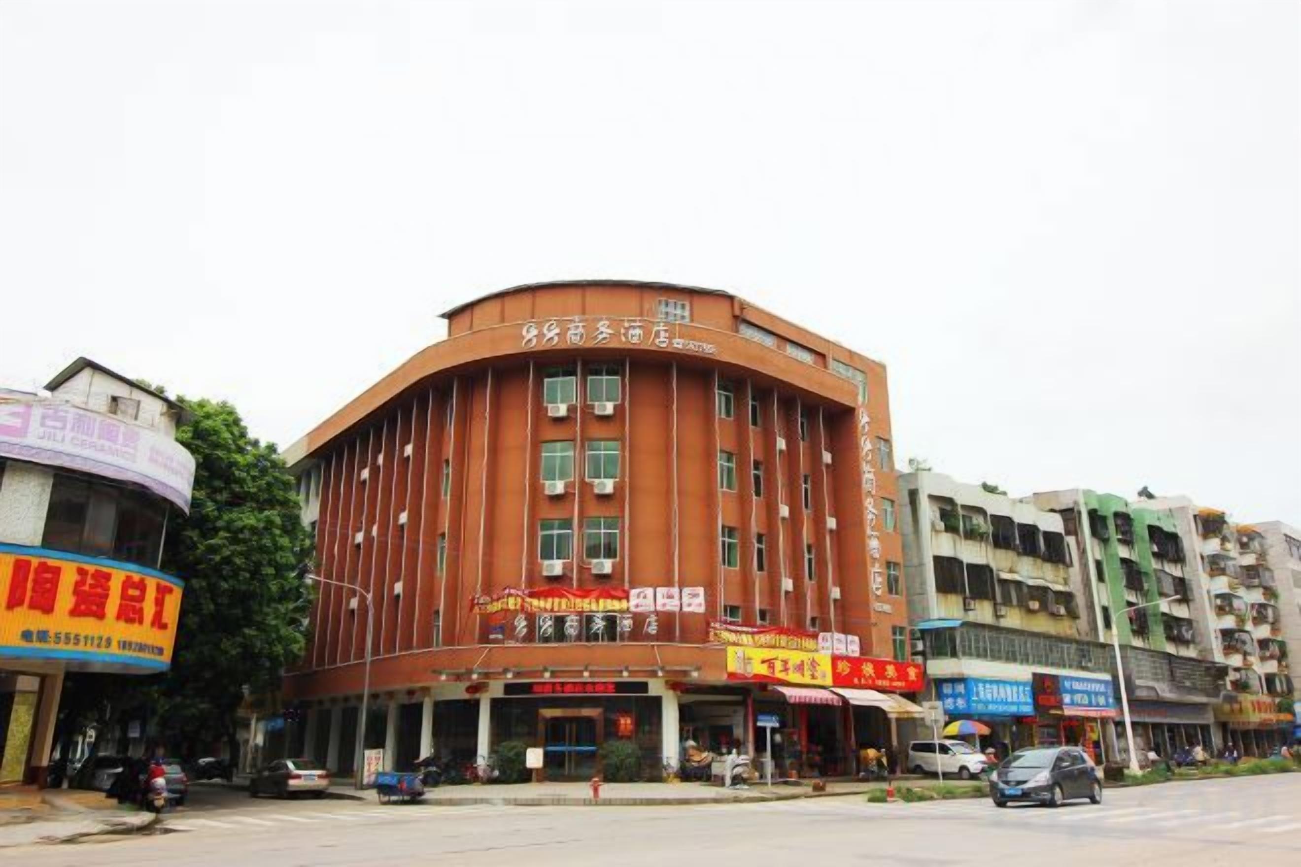 A multi-story hotel with a curved facade, multiple windows, and a visible entrance.