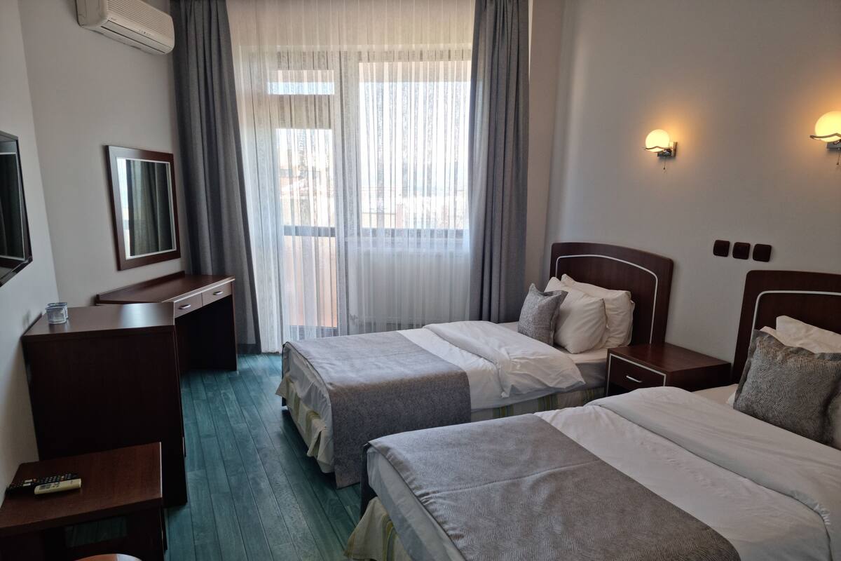 Standard Twin Room | Minibar, desk, laptop workspace, soundproofing