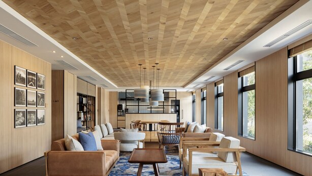 Ein geräumiges Wohnzimmer mit Holzboden, großen Fenstern und moderner Einrichtung.