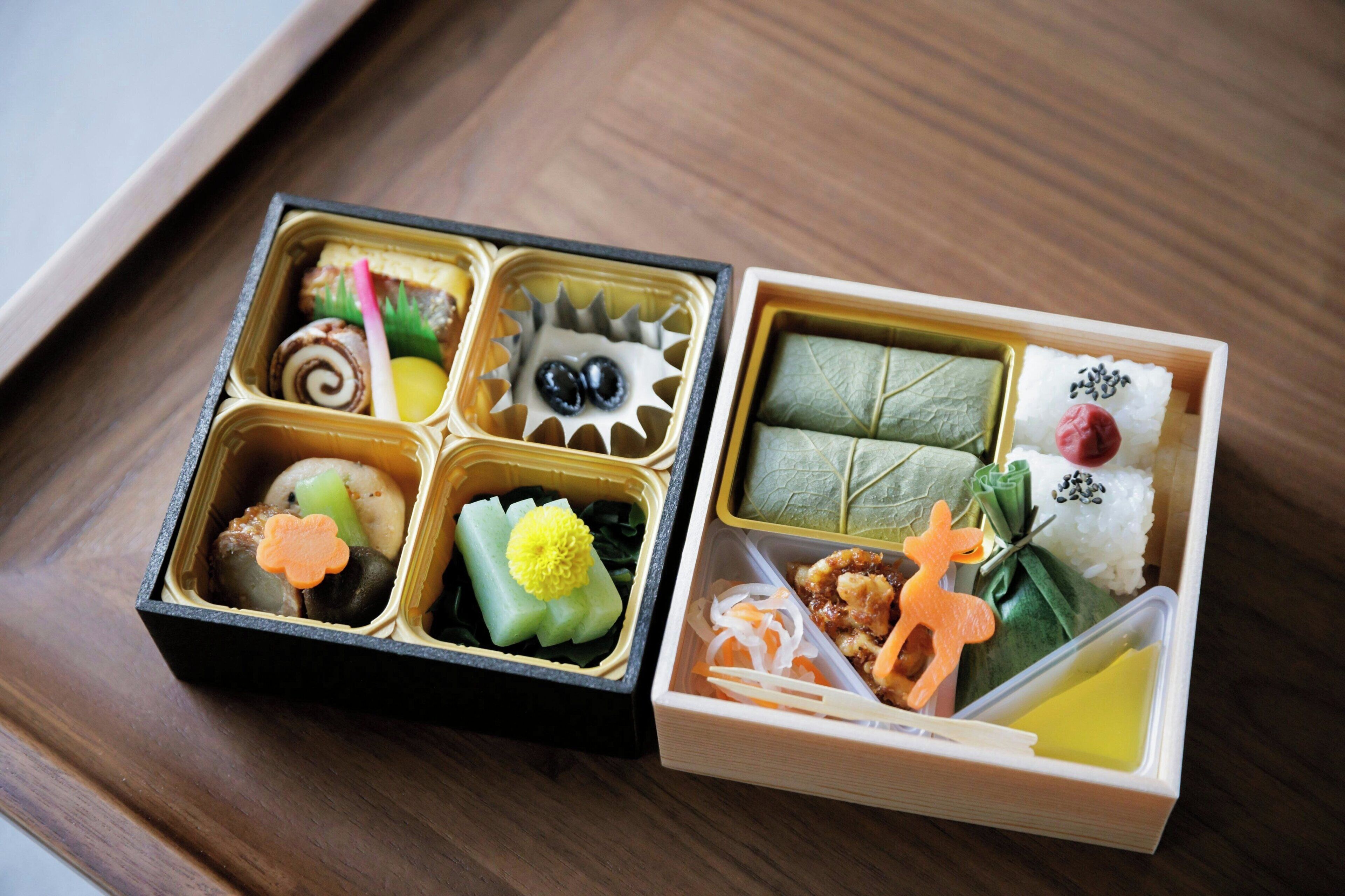 A bento box with various compartments containing different foods.