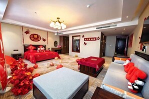A hotel room with a bed, sofa, and a TV. - Jinyue International Hotel (Changtu)