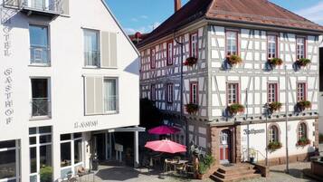 Experience the charm of a traditional European street scene, with a historic Gasthof and local eatery, perfect for a leisurely stroll.