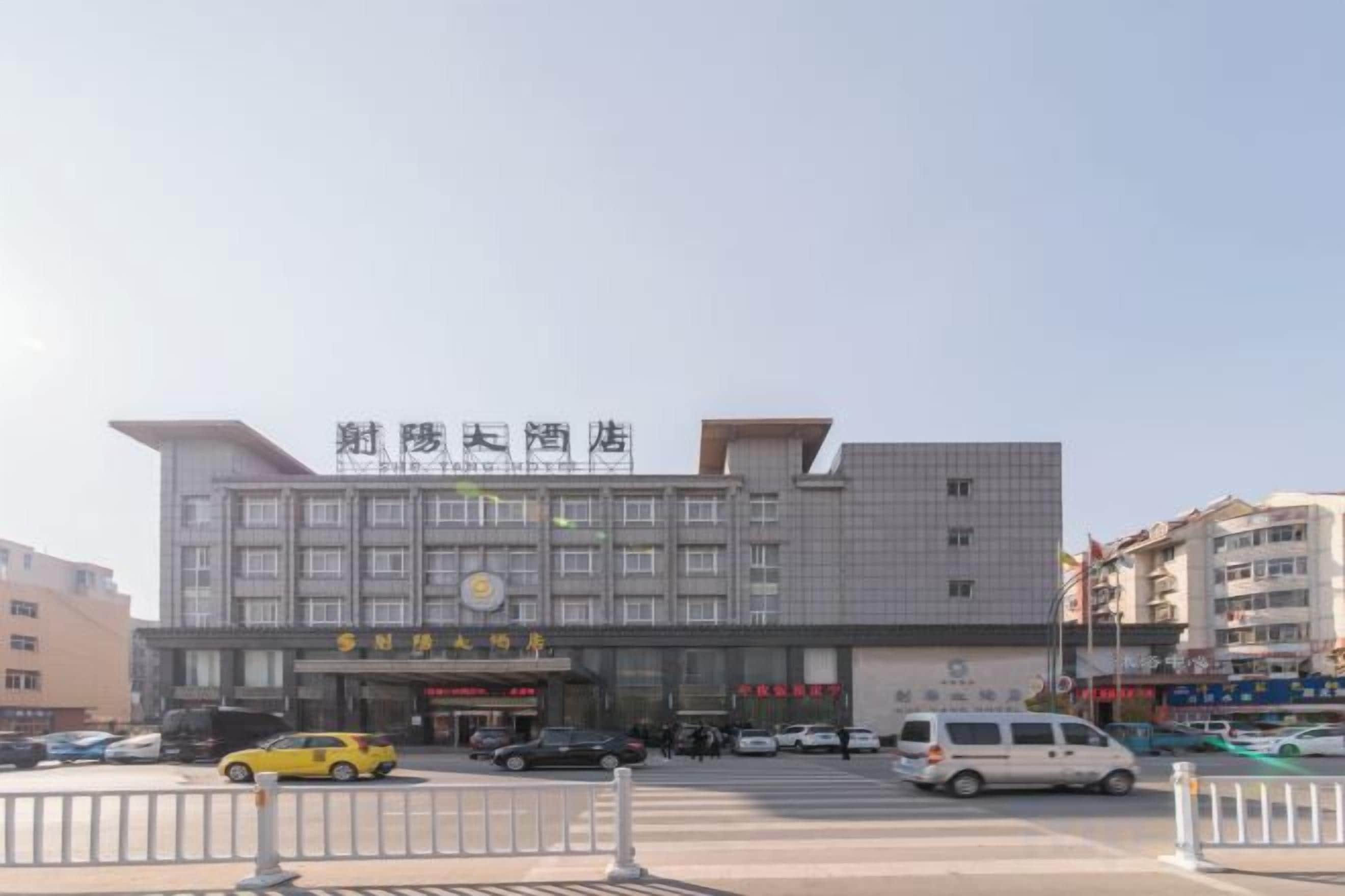 A multi-story building with a prominent sign at the top.