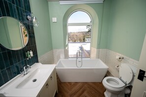 A bathroom with a bathtub, toilet, and sink. - Victoria Hotel Menai Bridge By Chef and Brewer Collection (Menai Bridge)