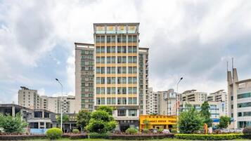 A multi-story hotel with a modern design, featuring a prominent entrance and a well-maintained facade.