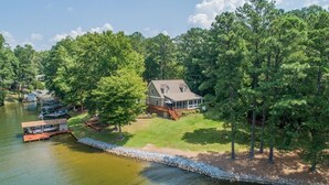 A lakeside property with a large house, dock, and boats. - Dog Friendly, 370+ ft of Waterfront, dock access and kayaks! (Littleton)