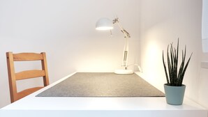 A desk with a chair, a desk lamp, and a potted plant. - Chic & bright apartment in Mülheim an der Ruhr (Mülheim an der Ruhr)