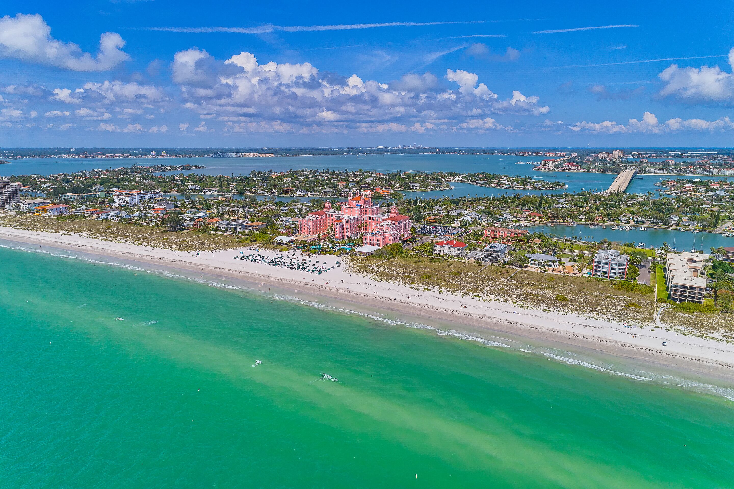A coastal resort with beachfront properties, a marina, and a large hotel complex.