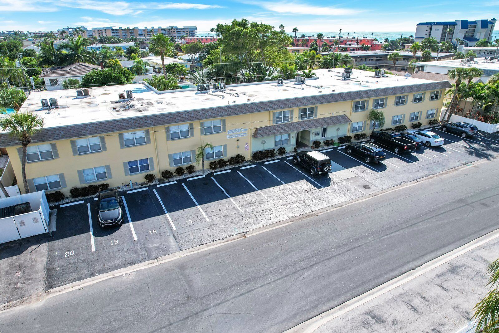 A multi-story hotel with a parking lot.