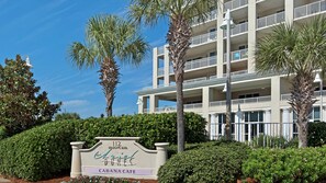 A multi-story hotel with a sign indicating '112 Seacape Blvd. Arica Dune Cabana Cafe'.
