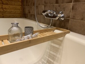 A wooden tray with a glass bottle and a textured metal container on a bathroom counter. - Romantic vacation apartment in a historic castle for 3-4 people (Nürnberg)