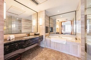 A modern bathroom with a marble vanity, a large mirror, a bathtub, and a shower area. - Nine Dragon Hotel (Gaoping)
