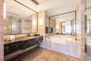 A modern bathroom with a marble vanity, a large mirror, a bathtub, and a shower area. - Nine Dragon Hotel (Gaoping)