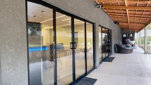 Un bâtiment moderne doté de grandes portes vitrées donnant accès à un espace piscine intérieure.