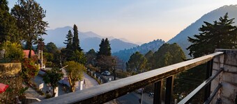 Peaceful, scenic, surrounded by green or snowy hills, far away from the city....