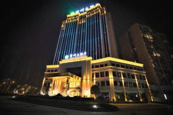 A multi-story hotel with illuminated signage and a prominent entrance.
