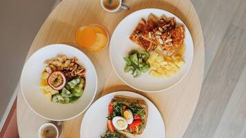 A breakfast tray with toast, fruit, and a cup of coffee.