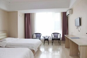 A hotel room with two beds, a desk, two chairs, a TV, and large windows with curtains. - Jinshang Express Motel (Shenyang)