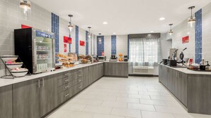 A modern kitchen with grey cabinets, a refrigerator, and a coffee machine. -  Best Western Plus Cleveland Inn & Suites (Cleveland)