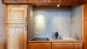 A kitchen with wooden cabinets, a granite countertop, and a built-in stove.