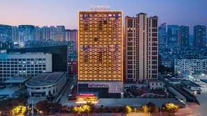 A high-rise hotel with a grid of windows and a sign reading "RAMADA BY WINDHAM". - Ramada by Wyndham Huangshi Huangshigang (Huangshi)