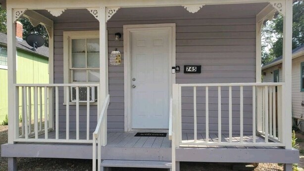 A two-story house with a porch, a front door, and a mailbox. - Stylish Retreat w/ Queen Bed • Fast WiFi • Free Parking (Colorado Springs)