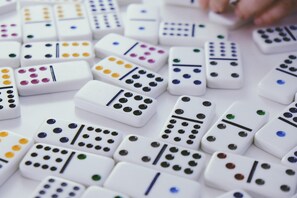 A collection of white dominoes with colorful dots and lines. - Suburban Studios Brunswick of I-95 (Brunswick)