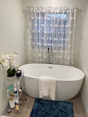 Bathtub, hair dryer, towels, soap