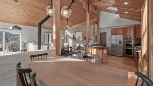A spacious kitchen with wooden cabinets, a large island, and modern appliances. - Durango Mountain House with Hot Tub and Views - great location (Durango)