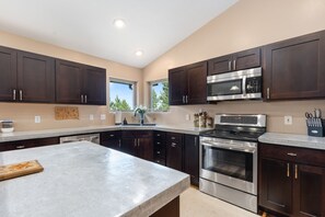 Enjoy cooking in this well-lit kitchen with a large island and sink.
