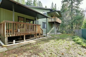 A two-story house with a wooden deck and a covered porch. - Timber Height's, Classy home in the pines. (Dunsmuir)