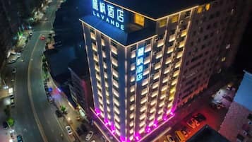 A multi-story hotel building with illuminated signage and a prominent entrance.