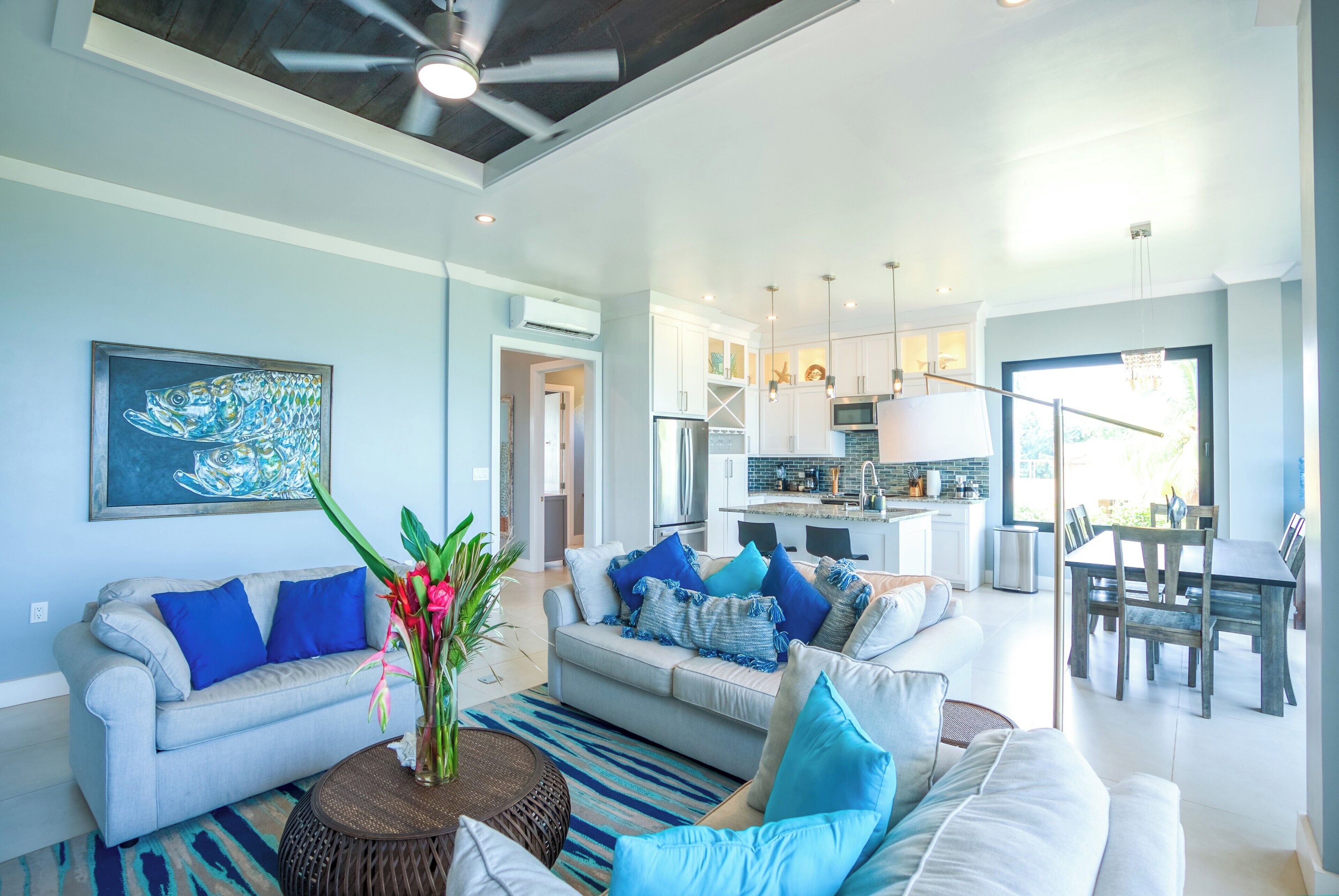 A modern living room with a sofa, coffee table, and artwork.