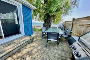 Enjoy al fresco dining on the patio with a barbecue grill and comfortable seating for four.