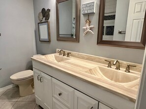A bathroom with a double sink vanity, a toilet, and two mirrors. - Flash Sale Completely updated 3/2 Sleeps 8 ML19 (Orange Beach)