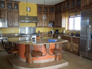 Enjoy cooking in this well-equipped kitchen with a central island and bar seating area.