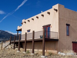 Guests can enjoy a balcony with a railing, taking in the scenic views of the surrounding mountains.