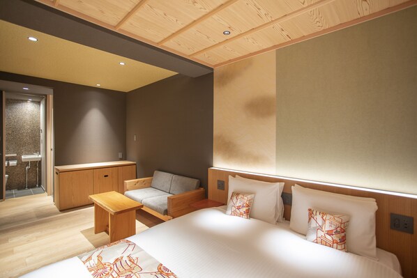 A modern hotel room with a large bed, a sofa, a small table, and a wooden cabinet. - HOTEL LEGASTA Kyoto Higashiyama Sanjo (Kyoto)