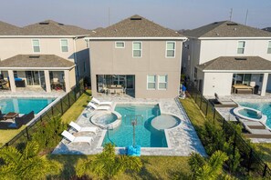 A residential building with a swimming pool, outdoor seating, and a basketball hoop. - Family Escape With Private Pool & Themed Rooms (Kissimmee)
