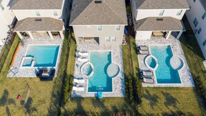 A residential complex with three houses, each featuring a swimming pool with sun loungers and a small deck area. - Family Escape With Private Pool & Themed Rooms (Kissimmee)