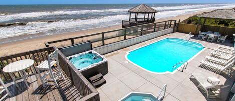 A rooftop pool with a view of the beach and ocean.