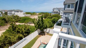 A residential area with houses, a swimming pool, and a view of the ocean. - Oceanside, 8 BRs, Private Pool, Theater Room, Rec Rm, Hot Tub, OL126, Knot Tide Up (Corolla)