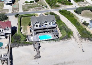 A large house with a swimming pool, a deck, and a beach area. - OCEANFRONT, 10 BRS, ELEV, Pool, Rec Rm, Theater Rm, OH1251, Beach Plaza (Corolla)
