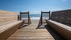 A wooden boardwalk leading to a beach with benches on either side. - OCEANFRONT, 10 BRS, ELEV, Pool, Rec Rm, Theater Rm, OH1251, Beach Plaza (Corolla)