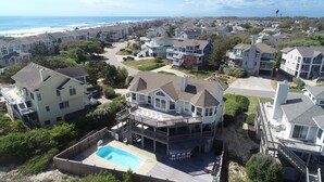A residential area with houses featuring large balconies and a swimming pool. - Semi-Oceanfront, Close to Beach Access, Private Pool, Hot Tub, 109, Happy Ours (Corolla)