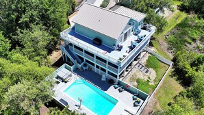 A multi-story building with a rooftop pool, outdoor seating, and a large deck area. - Soundfront, ELEV, Private Pool, Pool Table, Water Views, VOH1, Soundly Sea-Cluded (Corolla)