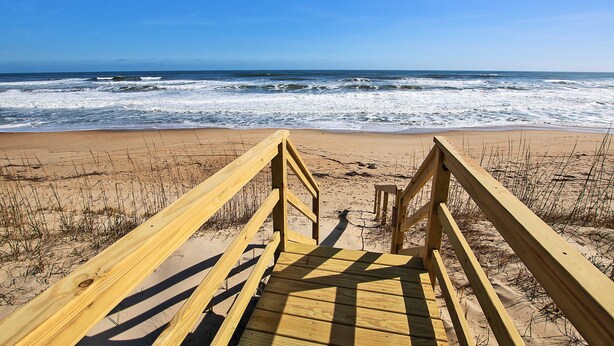 A wooden boardwalk leading to a beach with waves in the background. - OCEANFRONT, SUN-SUN, Pool, ELEV, Ocean Vws, PM100, Ships In (Duck)
