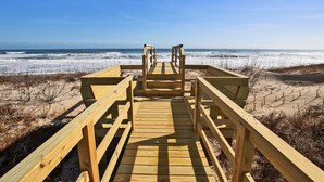 A wooden boardwalk leading to a beach with waves in the background. - OCEANFRONT, SUN-SUN, Pool, ELEV, Ocean Vws, PM100, Ships In (Duck)