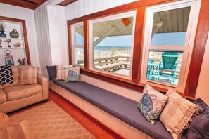 A cozy seating area with a cushioned bench, a wooden bench, and a sofa. - OCEANFRONT, Ocean views, Dogs Welcome! KH10, Beach House (Kitty Hawk)