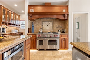 Enjoy cooking in this well-equipped kitchen with a central island, dishwasher, double oven, and large range.